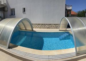 a swimming pool with a slide in front of a building at Angela's house in Zadar