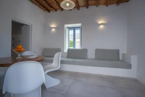 a living room with a couch and a table at Traditional White House in Prodromos Paros