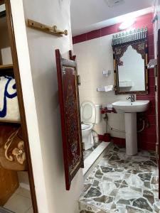 a bathroom with a sink and a toilet at Riad Malak in Meknès +91 photos