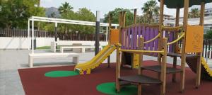 a playground with a slide in a park at Residencial El Trenet 2C in Benicàssim