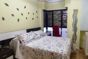 a bedroom with a bed and a window with butterflies on the wall at Los Bolardos in Zamora