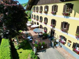 an aerial view of a building with tables and umbrellas at Lexenhof in Nussdorf am Attersee