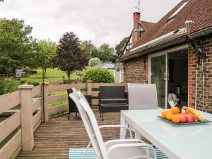 a white table and chairs on a wooden deck at Miswells Cottages - Lake View in Turners Hill