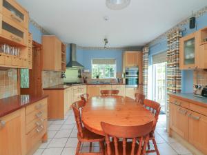 a large kitchen with a wooden table and chairs at Bolger House in Blackwater