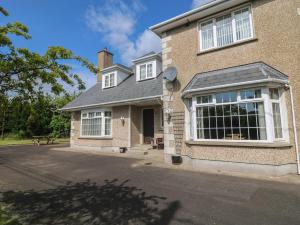 a large brick house with a large window at Bolger House in Blackwater