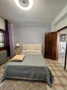 a bedroom with a large bed in a room at Villa Marina B&B in Cleto