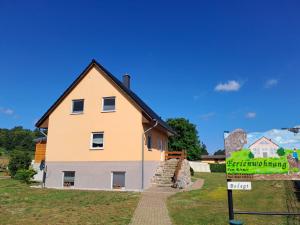 a house with a sign in front of it at Ferienwohnung Riemer in Garz