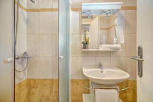 a bathroom with a sink and a shower at Lovely guest house Veli Vrh in Pula
