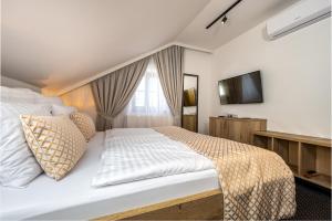 Postel nebo postele na pokoji v ubytování Penzion Golden Crown