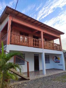 a house with a balcony on the side of it at kelly tours in Capurganá