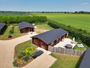 an aerial view of a house in a field at Cedar Lodge in Oakham