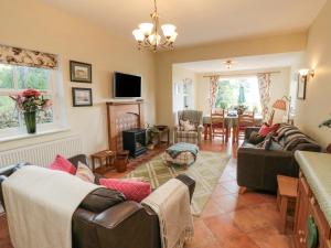 a living room with two couches and a fireplace at Sawdon Heights in Sawdon