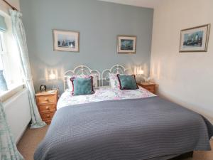 a bedroom with a large bed and two pillows at Sawdon Heights in Sawdon