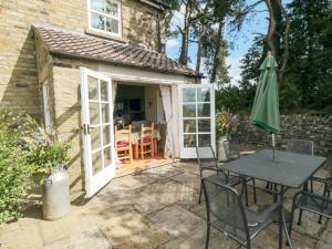 a patio with a table and an umbrella at Sawdon Heights in Sawdon