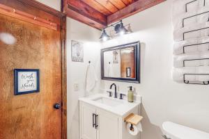 a bathroom with a sink and a mirror at Adventure Awaits in Rogers