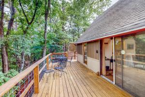a large wooden deck with a table and chairs on it at Adventure Awaits in Rogers