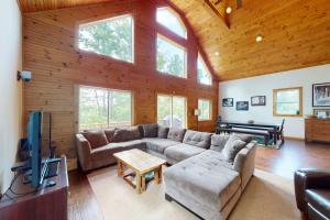 a living room with a couch and a flat screen tv at Shallow Brook in Jay