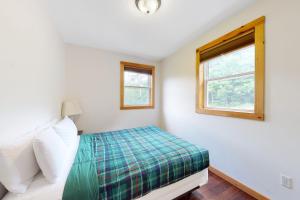 a bedroom with a bed and a window at Shallow Brook in Jay