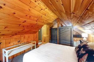 a bedroom with a large bed in a wooden cabin at The Evans House in Ellsworth +9 photos