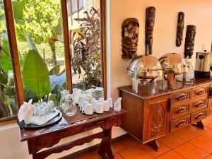 a table with plates and dishes on it next to a mirror at The Wood House in Empangeni +98 photos