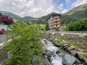 a river in front of a building next to a building at Apartamento MILU en Arinsal in Arinsal