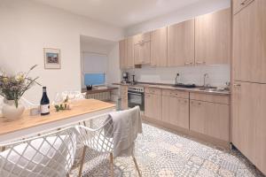 a kitchen with wooden cabinets and a table and chairs at Adam&Eva in Bamberg