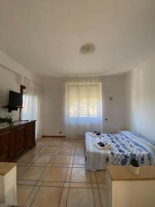 a bedroom with a bed and a television in it at Fonzi’s House in La Spezia