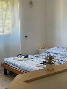 a bedroom with a bed with a plant on it at Fonzi’s House in La Spezia