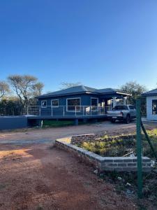 a blue house with a car parked in front of it at Kings view exclusive villas (KVEV) in Pretoria-Noord