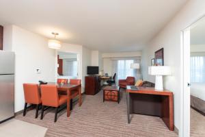 a living room with a kitchen and a dining room at Residence Inn by Marriott Austin - University Area in Austin