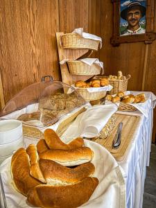a table topped with lots of different types of bread at Turistické ubytovanie Sova in Ždiar