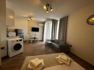 a living room with a couch and a washing machine at Golden Sands Apartments Zlatna Kotva in Golden Sands