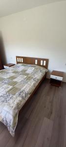 a bedroom with a bed and a wooden floor at Damjan's Apartments 