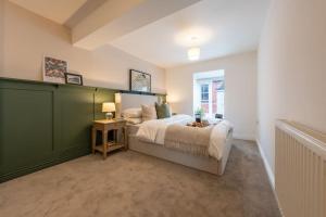 a bedroom with a large bed and a window at Stylish, comfortable, convenient! in Bala