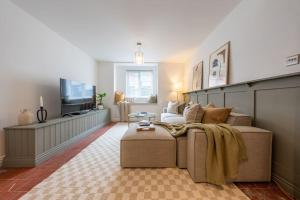a living room with a couch and a tv at Stylish, comfortable, convenient! in Bala