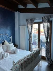 a bedroom with a bed with blue walls at B&B Savoia San Salvo in San Salvo