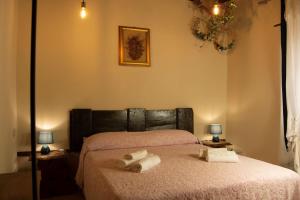 Кровать или кровати в номере L'Archetto su Civita