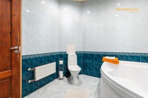 a bathroom with a toilet and a bath tub at Daily Apartments - Old Town Fat Margaret in Tallinn