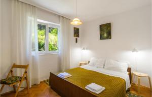 a bedroom with a large bed with a yellow blanket at Nice Home In Jelsa With 3 Bedrooms And Wifi in Jelsa