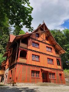 a large wooden house sitting on top of a street at Villa Winkler in Miedzygorze