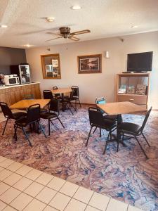 a conference room with tables and chairs and a tv at Arlington Inn in Arlington