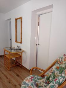 a room with a table and a chair and a mirror at Villa Garrido in El Pozo de los Frailes