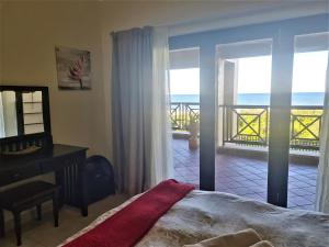 a bedroom with a bed and a view of the ocean at Bondi Beach 64 in Margate +19 photos