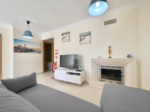 a living room with a fireplace and a tv at Baleal Happy Family Apartment in Ferrel