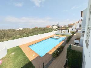 a swimming pool on the side of a building at Baleal Happy Family Apartment in Ferrel