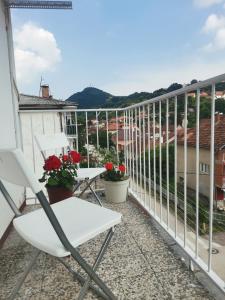 a white chair on a balcony with a view at FARIS in Donji Milanovac