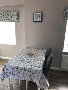 a dining room table with a blue and white table cloth at Cosy Nook Cottage Kesh in Kesh