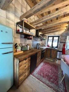 a kitchen with wooden cabinets and a refrigerator at El 15 de Betren in Betrén