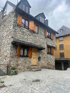 a large stone building with a door and windows at El 15 de Betren in Betrén +31 photos