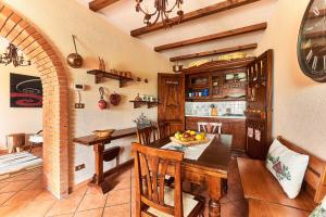 a kitchen with a table and a dining room at La Scalinatella in Rivisondoli